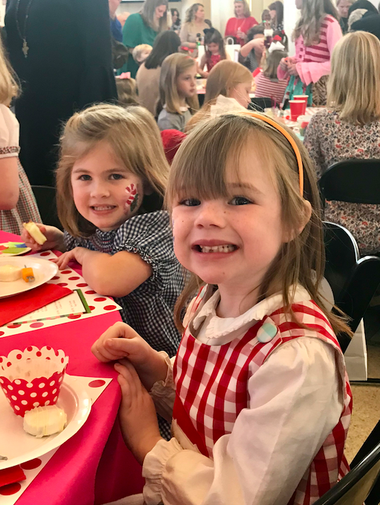 Two children working on a craft. 