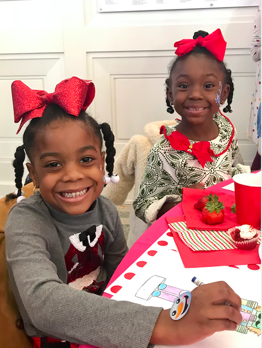 Two children working on a craft. 