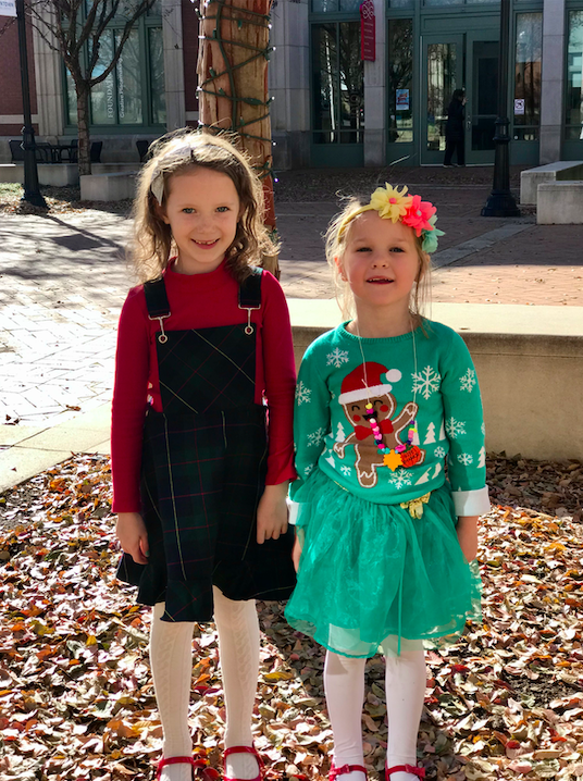 Two small girls wearing Christmas outfits