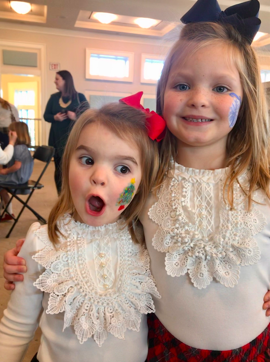 Two small girls with face paint.