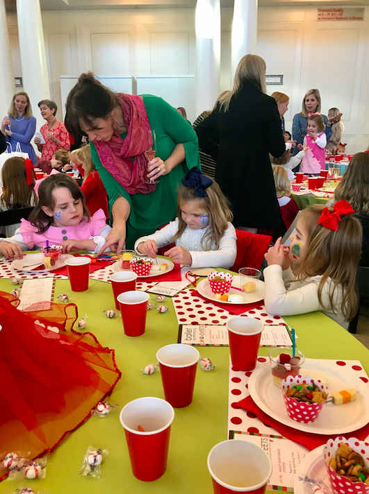 Parent helping children with crafts.